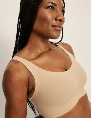 Front view of model wearing the Revolution Adjustable Pullover Bra, highlighting the neckline, strap design, and  silhouette