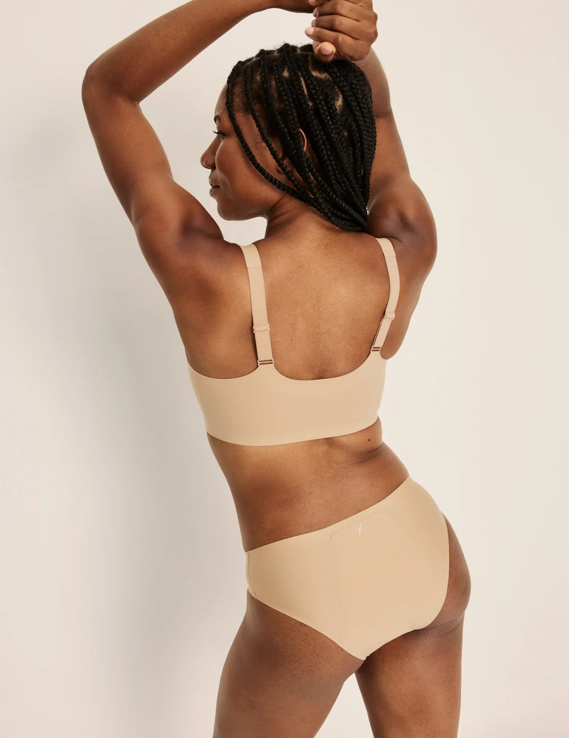 Gin is a 34DD and wearing KNIX M+ | Back view of model wearing the Revolution Adjustable Pullover Bra, highlighting the neckline, strap design, and  silhouette | Warm Sand