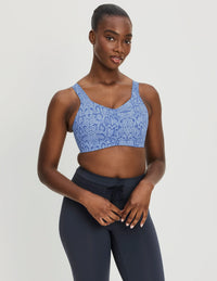 Full-body view of model wearing the Catalyst Sports Bra, highlighting the neckline, strap design, and smooth silhouette