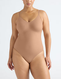 Front view of model wearing the LuxeLift Bodysuit highlighting the neckline, strap design and fit