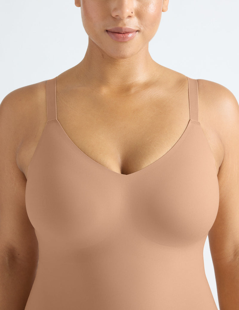 Front view of model wearing the LuxeLift Bodysuit highlighting the neckline, strap design and fit
