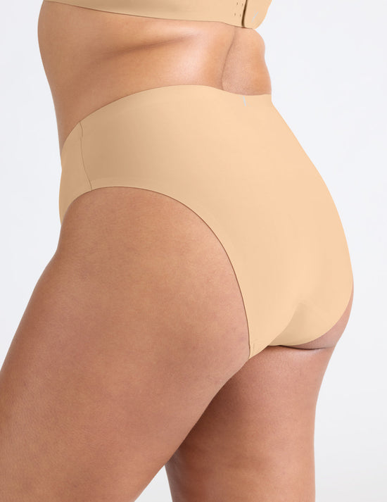 Adiya has 43" hips and wears a Knix size L | Warm Sand