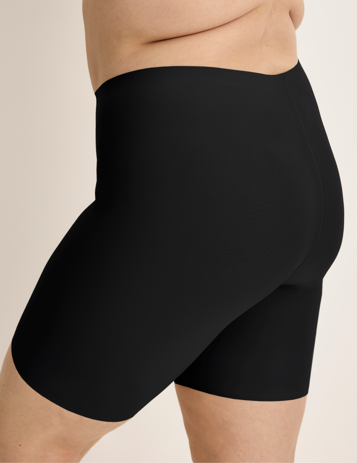 Beatrice is wearing KNIX XL | Side view of model wearing the Thigh Saver® 6” highlighting the coverage and smooth fit | Black