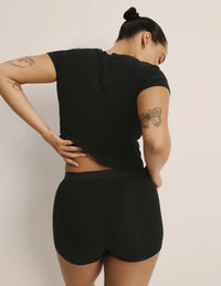 Andie is a 34E and is wearing a Knix size M | Black