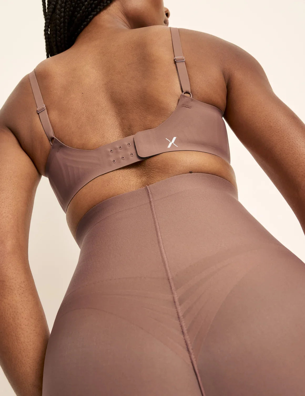 Gin has 38” hips, is 5’8” tall and wears a size S  | Back view of model wearing the Customizable Shaper High Rise Leakproof Shorts, highlighting the coverage and smooth fit | Sola