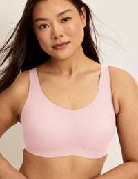 Front view of model wearing the Revolution Adjustable Pullover Bra, highlighting the neckline, strap design, and  silhouette