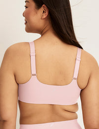 Back view of model wearing the Revolution Adjustable Pullover Bra, highlighting the neckline, strap design, and  silhouette