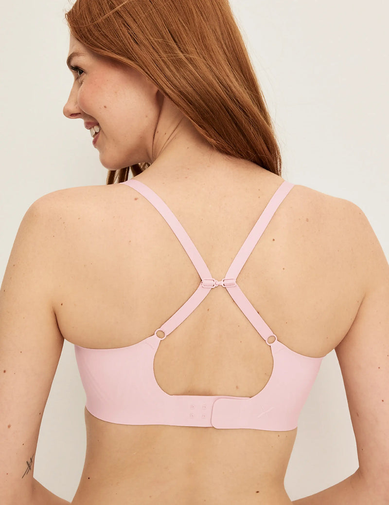 Back view of model wearing the Revolution Scoop Bra, highlighting the neckline, strap design, and smooth silhouette