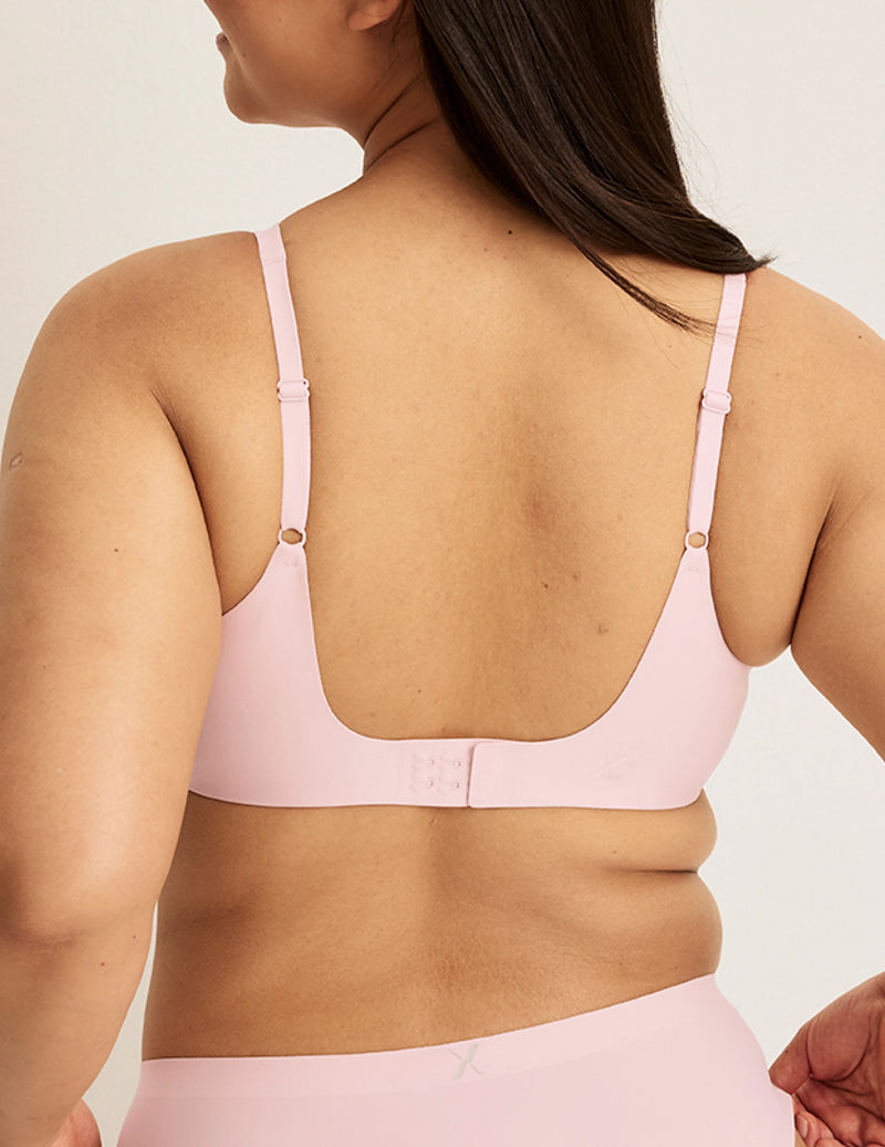 Back view of model wearing the Revolution Shadow Mesh Bra, highlighting the neckline, strap design, and  silhouette