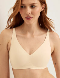 Front view of model wearing the Revolution V-Neck Bra, highlighting the neckline, strap design, and smooth silhouette