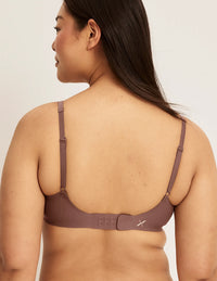 Back view of model wearing the Revolution V-Neck Bra, highlighting the neckline, strap design, and smooth silhouette