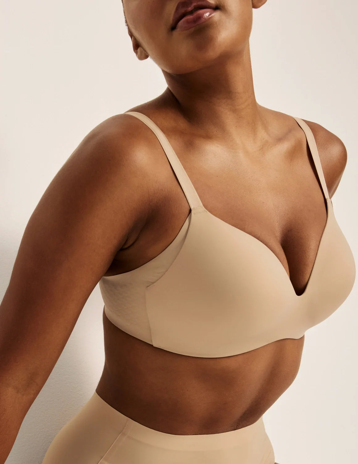 Amber is wearing a 36C | Front view of model wearing the WingWoman Contour Bra, highlighting the neckline, strap design, and  silhouette | Warm Sand